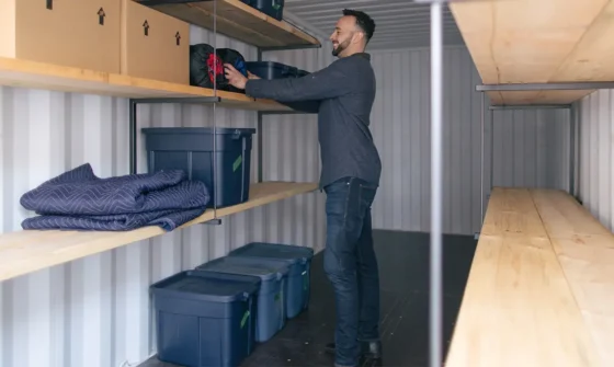 Man loading items into a portable storage container - BigSteelBox