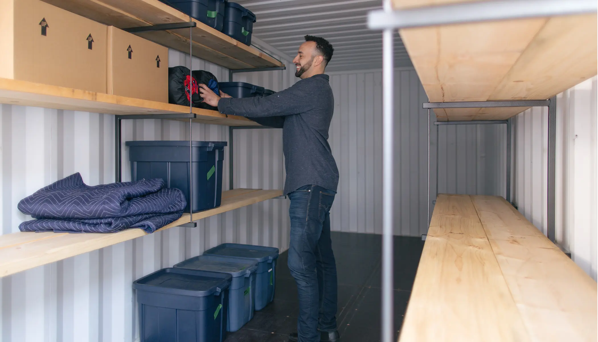 Man loading items into a portable storage container - BigSteelBox